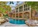 The backyard features a stunning pool, stone patio, and covered porch, perfect for outdoor entertaining and relaxation at 1285 Wesley Nw Pl, Atlanta, GA 30327