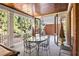 Covered and screened porch with outdoor dining furniture and view of the backyard at 1285 Wesley Nw Pl, Atlanta, GA 30327