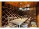 Climate-controlled wine cellar with custom racking, a tasting table, and overhead lighting at 1285 Wesley Nw Pl, Atlanta, GA 30327