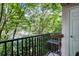 Cozy balcony featuring a metal railing and lush green tree views at 1850 Cotillion Dr # 4306, Dunwoody, GA 30338