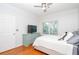 Cozy bedroom with a comfy bed, light-colored walls, hardwood floors, and a window overlooking greenery at 1850 Cotillion Dr # 4306, Dunwoody, GA 30338
