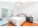 Bright bedroom with a double bed, light walls, hardwood floors, and natural light from a large window at 1850 Cotillion Dr # 4306, Dunwoody, GA 30338