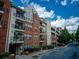 Condominium building featuring brick facade, balconies, and convenient parking deck for residents at 1850 Cotillion Dr # 4306, Dunwoody, GA 30338