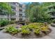 Beautiful courtyard with a small wooden bridge over a decorative pond surrounded by lush greenery at 1850 Cotillion Dr # 4306, Dunwoody, GA 30338