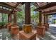 Exterior courtyard featuring a charming wooden pergola, brick columns, and lush landscaping at 1850 Cotillion Dr # 4306, Dunwoody, GA 30338