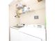 Functional laundry area featuring modern washer and dryer units with overhead shelving for storage at 1850 Cotillion Dr # 4306, Dunwoody, GA 30338