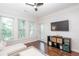 Airy living room with hardwood floors and large windows offering plenty of natural light at 1850 Cotillion Dr # 4306, Dunwoody, GA 30338