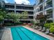 Relaxing swimming pool with mature landscaping and comfortable lounge chairs for residents at 1850 Cotillion Dr # 4306, Dunwoody, GA 30338