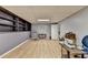 Finished basement with laminate floors, built in shelving, and natural light from window at 1900 Shady Creek Ln, Lawrenceville, GA 30043