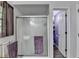 Bathroom with glass shower doors, tile flooring, and a purple color scheme at 1900 Shady Creek Ln, Lawrenceville, GA 30043
