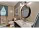 Bathroom featuring a round mirror, neutral tones, and white vanity at 1900 Shady Creek Ln, Lawrenceville, GA 30043
