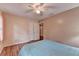 Bedroom featuring hardwood floors, a ceiling fan, and ample closet space at 1900 Shady Creek Ln, Lawrenceville, GA 30043