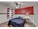 Bedroom with a ceiling fan, hardwood floors, and a red accent wall at 1900 Shady Creek Ln, Lawrenceville, GA 30043