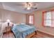 Cozy bedroom with hardwood floors, ceiling fan and natural light from two windows at 1900 Shady Creek Ln, Lawrenceville, GA 30043