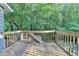 View from a wood deck and railing with steps leading to the backyard at 1900 Shady Creek Ln, Lawrenceville, GA 30043