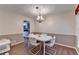 Traditional dining room featuring a white table, chandelier, and wood-look flooring at 1900 Shady Creek Ln, Lawrenceville, GA 30043