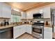 Kitchen features white cabinets, wood ceiling, stainless steel appliances, and breakfast nook at 1900 Shady Creek Ln, Lawrenceville, GA 30043