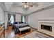 Primary bedroom features a tray ceiling, fireplace and decorative rug at 1900 Shady Creek Ln, Lawrenceville, GA 30043