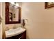 Traditional powder room with wood mirror, vanity, and light fixture at 1900 Shady Creek Ln, Lawrenceville, GA 30043