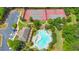 Aerial view of community featuring tennis courts, parking, a clubhouse, and a freeform pool with inviting lounge chairs at 2534 Grayton Loop, Villa Rica, GA 30180