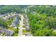 The aerial view captures the neighborhood's layout, with houses nestled among lush trees and a serene lake nearby at 2534 Grayton Loop, Villa Rica, GA 30180