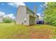 Expansive backyard featuring a well-maintained lawn and a charming covered patio area, ideal for outdoor relaxation at 2534 Grayton Loop, Villa Rica, GA 30180