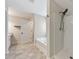 Bathroom featuring a tub, shower, and neutral toned tile at 2534 Grayton Loop, Villa Rica, GA 30180