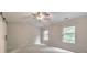 Bright, carpeted bedroom with a ceiling fan and two windows at 2534 Grayton Loop, Villa Rica, GA 30180