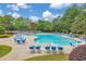 Large community pool with lounge chairs and tables, providing a relaxing and social gathering spot for residents at 2534 Grayton Loop, Villa Rica, GA 30180