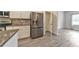 Spacious kitchen features stainless appliances, granite counters, white cabinetry and easy access to walk-in pantry at 2534 Grayton Loop, Villa Rica, GA 30180