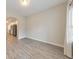 Open-concept room features gray vinyl floors, neutral walls, and a view into an adjacent kitchen at 2534 Grayton Loop, Villa Rica, GA 30180