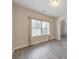 Bright living room featuring neutral-toned walls, gray vinyl floors, a ceiling light, and large window at 2534 Grayton Loop, Villa Rica, GA 30180