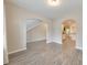 Open-concept room features gray vinyl floors, neutral walls, and archway entrances to other spaces at 2534 Grayton Loop, Villa Rica, GA 30180