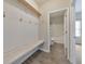 Mud room with a built-in bench, shelf, and hooks, providing practical storage solutions at 2534 Grayton Loop, Villa Rica, GA 30180