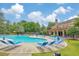 Resort-style community pool with ample lounge seating and a clubhouse, surrounded by lush landscaping and blue skies at 2534 Grayton Loop, Villa Rica, GA 30180