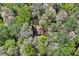 Aerial view of a secluded home nestled among mature trees, offering privacy and tranquility at 4730 Geneva Sw Dr, Lilburn, GA 30047