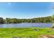 Aerial view of a serene lake surrounded by lush trees, complete with grassy shoreline at 4730 Geneva Sw Dr, Lilburn, GA 30047