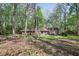 Spacious backyard with mature trees and a well-maintained lawn, offering a serene and private outdoor space at 4730 Geneva Sw Dr, Lilburn, GA 30047