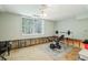 Basement with a ceiling fan, unfinished walls, and gym equipment, offering potential for a workout area at 4730 Geneva Sw Dr, Lilburn, GA 30047