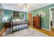 Cozy bedroom with hardwood floors, a comfortable bed, and ample natural light from the window at 4730 Geneva Sw Dr, Lilburn, GA 30047