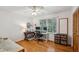 Versatile bedroom with hardwood floors, ample natural light, and a dedicated workspace at 4730 Geneva Sw Dr, Lilburn, GA 30047