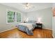 Light-filled bedroom with hardwood floors, large window, and a ceiling fan for added comfort at 4730 Geneva Sw Dr, Lilburn, GA 30047