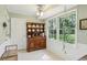 Bright breakfast nook with vintage hutch and large windows offering outdoor views at 4730 Geneva Sw Dr, Lilburn, GA 30047