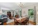 Inviting dining room featuring hardwood floors, a chandelier, and abundant natural light from the surrounding windows at 4730 Geneva Sw Dr, Lilburn, GA 30047