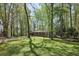 Charming brick home nestled among mature trees, featuring a spacious driveway and a well-manicured lawn at 4730 Geneva Sw Dr, Lilburn, GA 30047