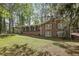 Charming brick home with covered carport and lush green lawn showcasing curb appeal and serene setting at 4730 Geneva Sw Dr, Lilburn, GA 30047