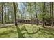Brick home with a spacious carport surrounded by trees, features an expansive front lawn at 4730 Geneva Sw Dr, Lilburn, GA 30047