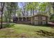Charming brick home with a spacious carport, surrounded by lush trees and a well-maintained lawn at 4730 Geneva Sw Dr, Lilburn, GA 30047