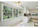 Bright kitchen nook with views of the backyard, and hanging pothos at 4730 Geneva Sw Dr, Lilburn, GA 30047