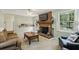 Bright living room features a brick fireplace, ceiling fan, and access to the outdoors at 4730 Geneva Sw Dr, Lilburn, GA 30047